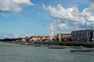 View of the promenade of the resort town and the Ferris wheel on a sunny summer day, Zelenogradsk,...