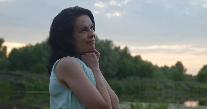 Happy Woman Enjoys Rest Relax on Nature Near River. Summer Season Sunset. Rural Country Scene 4K