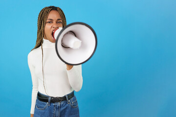 Fototapeta na wymiar Angry african woman protesting while using a loudspeaker