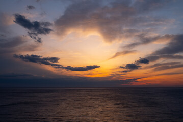 Beautiful orange sunset over the Black Sea. Evening sea with waves.