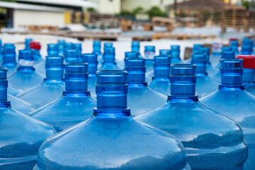 many large plastic water bottles