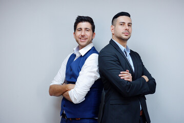 Handsome young businessman in suit smiling on white background. Business concept.