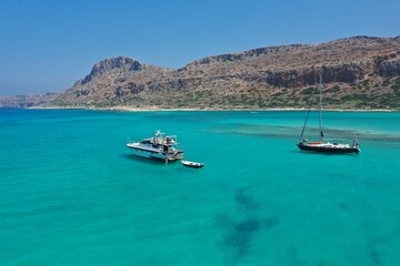 Naklejka na ściany i meble Calm blue sea on a sunny day. Yachts with turists are sailing on Libian sea .