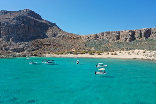 Calm blue sea on a sunny day. Yachts with turists are sailing on Libian sea .