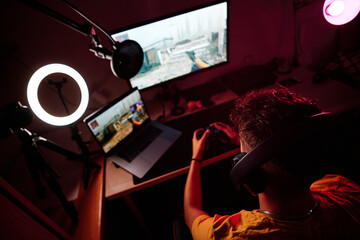 Top view of a gamer sitting in a room playing alone