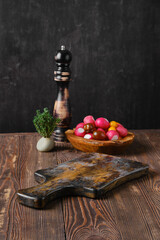 Rustic kitchen table with fresh vegetables and pepper mill on background