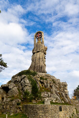 Baiona, Spain - December 05, 2022: sculpture dedicated to the Virgin of the Rock on a mountain near the town of Baiona, Spain