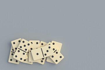 Heap of domino tiles in corner on gray background. Board game. Top view. Space for text. 3d render