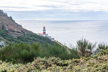 Baiona, Spain - December 05, 2022: maritime lighthouse in the atlantic ocean called faro silleiro, tourist place, in the town of Baiona, Spain