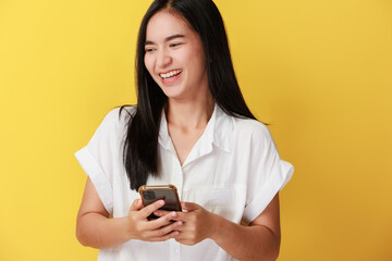 Portrait of positive cheerful girl use smart phone share social media news wear style stylish trendy isolated over yellow color background