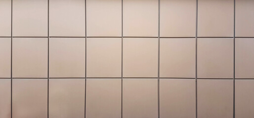light facing tiles on the wall of a city building