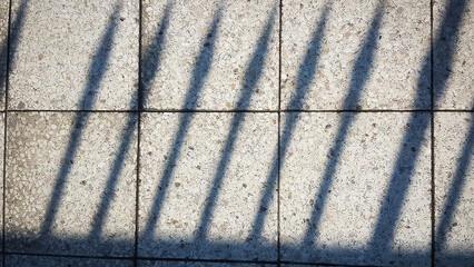 shadows from the railing on floor marble tile. background