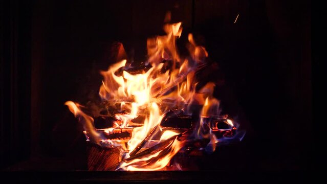 Beautiful shot of camp and fireplace fire burning in the dark at night.