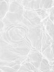 Naklejka premium Defocus blurred transparent white colored clear calm water surface texture with splashes and bubbles. Trendy abstract nature background. Water waves in sunlight with copy space. White water shine