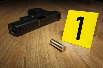 Crime Scene Investigation - .357 magnum bullet casing as a piece of evidence placed with yellow...