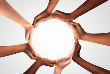 Conceptual symbol of multiracial human hands making a circle on white background with a copy space...