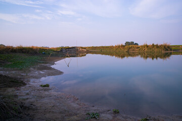 Arial View Canal with green grass and vegetation reflected in the water nearby Padma river in Bangladesh