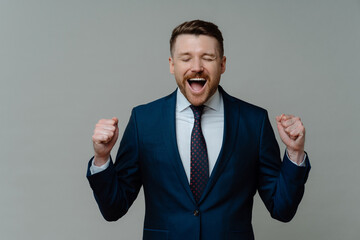 Excited businessman in suit screaming and celebrating success