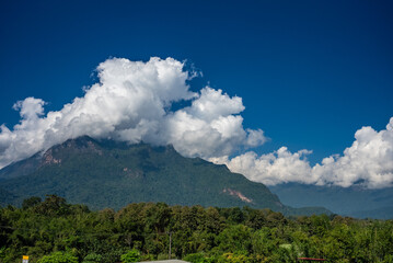 Fototapeta na wymiar Majestic view of Doi Luang Chiang Dao in northern Thailand, the third highest mountain in Thailand, seen with beautiful dramatic clouds and colorful sky