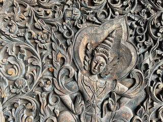 detail of a budhist theme wood carving