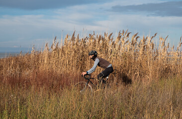 Men riding gravel bike on gravel road.Sport motivation. Male cyclist is training on gravel road.