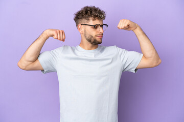 Delivery caucasian man isolated on purple background doing strong gesture