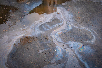 Beautiful abstract colorful background, stains of motor oil in a puddle with reflection of a building in blur
