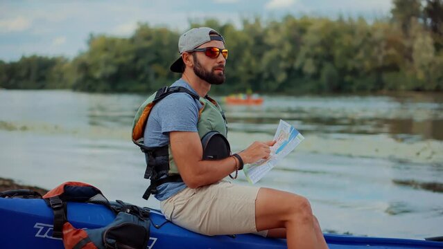 Traveling on river and holding  tourist map to navigate