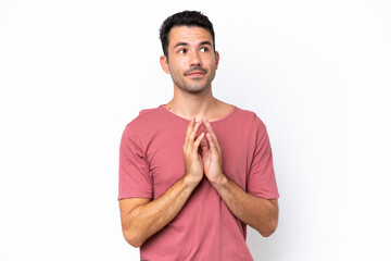 Young handsome man over isolated white background scheming something