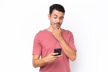 Young handsome man over isolated white background thinking and sending a message