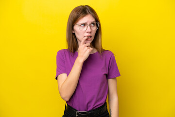 Young English woman isolated on yellow background nervous and scared