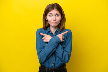 Young English woman isolated on yellow background pointing to the laterals having doubts