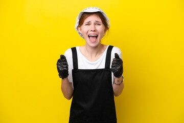 Young English fisherwoman isolated on yellow background celebrating a victory in winner position