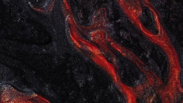 Dramatic artistic background video of movement lava . Footage with liquid shining orange flow. Abstract black texture with red-hot magma. Smartphone wallpaper or theme. Fluid art.