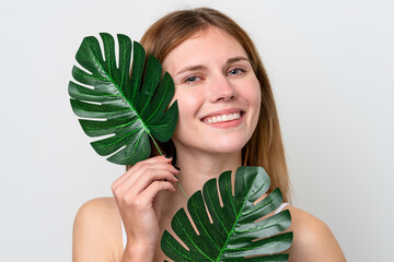 Young English woman holding a palm leaf with happy expression. Close up portrait