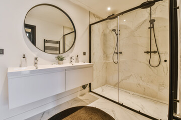 a modern bathroom with marble flooring and black framed mirrors on the wall above the bathtub is an...