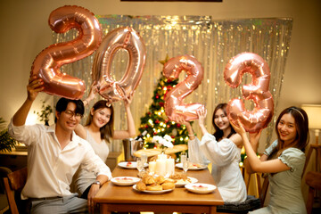 At the party 4 friends prepare to celebrate by holding the numbers 2023