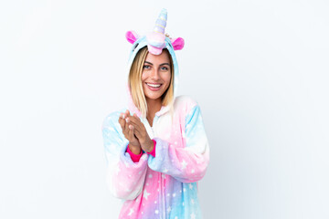 Obraz na płótnie Canvas Blonde Uruguayan girl wearing a unicorn pajama isolated on white background applauding after presentation in a conference