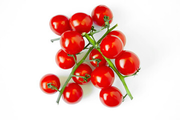 Top view of a branch with ripe cherry tomatoes. Vegetables from red tomatoes on a white background