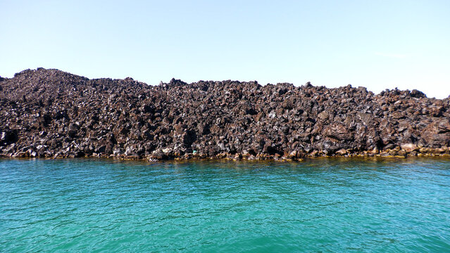 Frozen lava. Palia Kameni, island of volcanic origin. Santorini, Greece.
