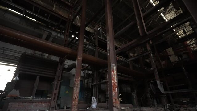 The interior of the destroyed production in the factory since the days of the Soviet Union. Dolly camera shot