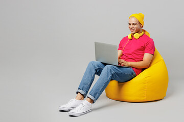 Full body fun young IT man of African American ethnicity 20s he wear pink t-shirt yellow hat...