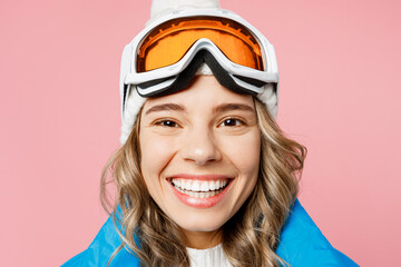 Close up snowboarder happy fun woman wear blue suit goggles mask hat ski padded jacket spend extreme weekend ook camera isolated on plain pastel pink background. Winter sport hobby trip relax concept.