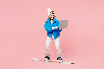 Snowboarder IT woman wear blue suit goggles mask hat ski jacket work hold use laptop pc computer...