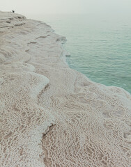 The coastline of the Dead Sea with patterns of salt