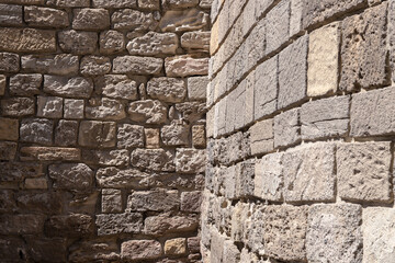 Fragment of rough stone wall made of textured blocks of various size and shape, Baku, Azerbaijan