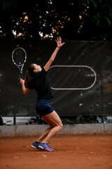 Fototapeta na wymiar view of active sporty woman tennis player with tennis racket in hand doing pitch