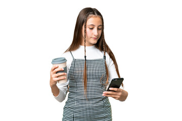 Young girl over isolated chroma key background holding coffee to take away and a mobile