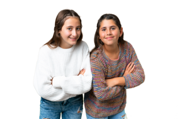 Friends girls over isolated chroma key background keeping the arms crossed while smiling