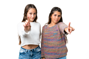 Friends girls over isolated chroma key background showing and lifting a finger